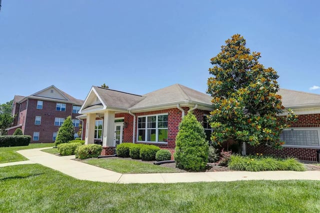 Brick building with large windows and trees exterior at Eagles Landing Apartments in Cookeville Student Accommodation