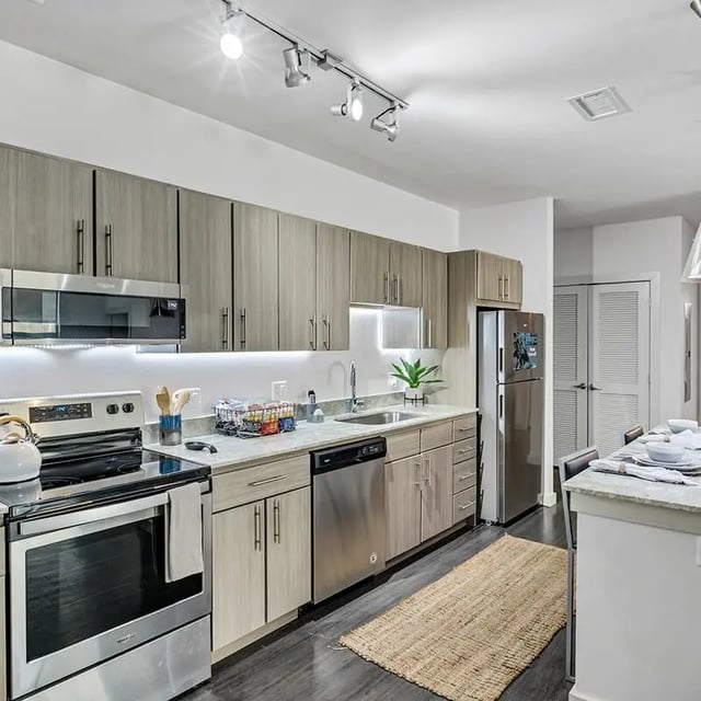 Modern kitchen with stainless steel appliances and cabinets kitchen at Aspire Tucson Apartments in Tucson Student Accommodation