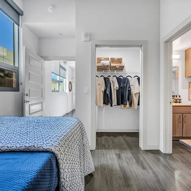 Bed with closet and bathroom visible bedroom at Aspire Tucson Apartments in Tucson Student Accommodation