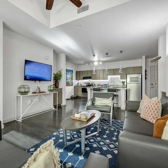 Modern living room with sectional sofa kitchen living room at Aspire Tucson Apartments in Tucson Student Accommodation
