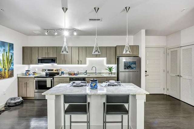 Modern kitchen with island refrigerator and appliances kitchen at Aspire Tucson Apartments in Tucson Student Accommodation