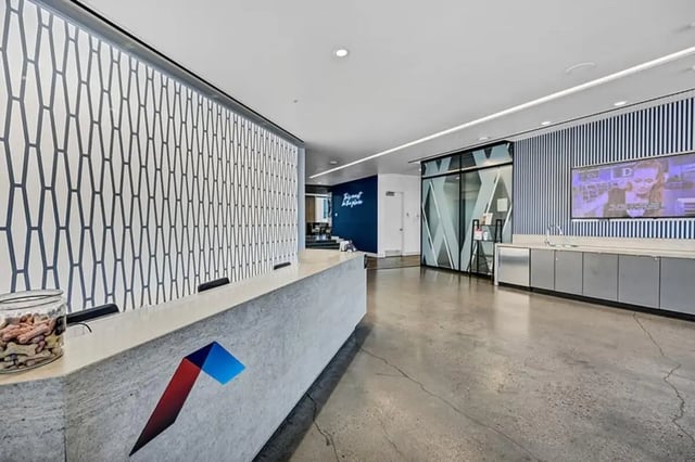Lobby reception desk modern design geometric wall reception area at Aspire Tucson Apartments in Tucson Student Accommodation