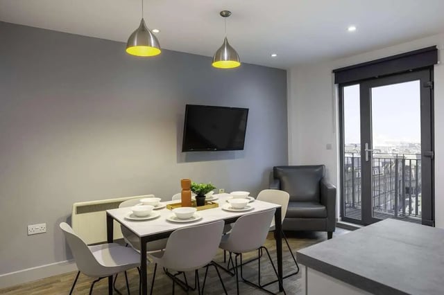 Dining table with chairs and TV living room at The Bridge Phase II in Newcastle Upon Tyne Student Accommodation