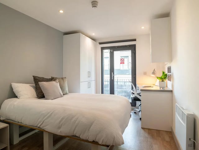 Bed desk wardrobe and balcony student bedroom at The Bridge Phase II in Newcastle Upon Tyne Student Accommodation