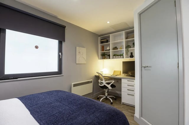 Bed desk chair shelves and computer Study Area at The Bridge Phase II in Newcastle Upon Tyne Student Accommodation