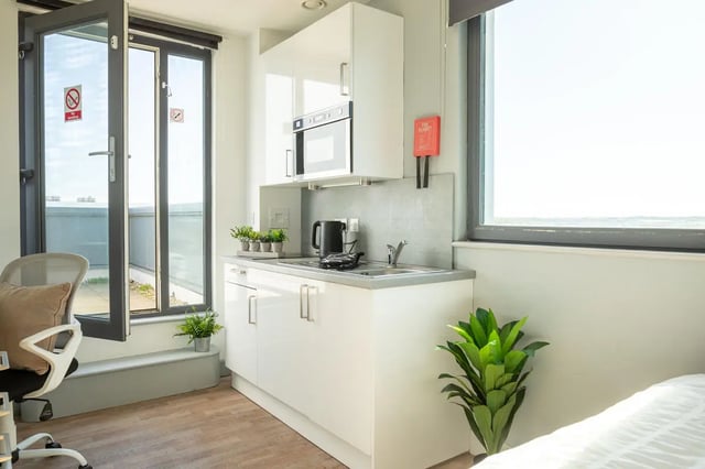 Modern studio kitchen with microwave kettle and plants kitchen at The Bridge Phase II in Newcastle Upon Tyne Student Accommodation