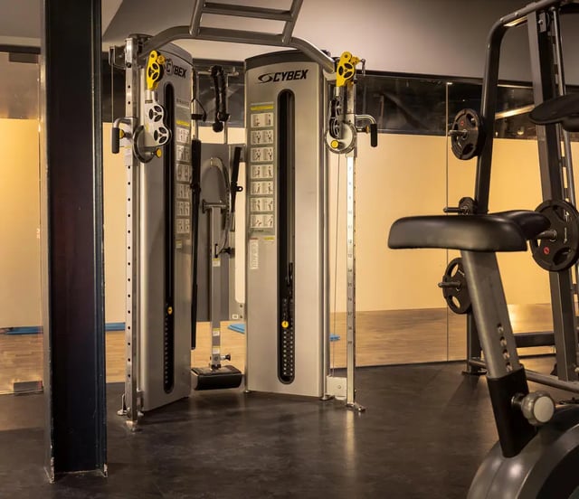 Gym equipment with weights and mirrors gym at The Bridge Phase II in Newcastle Upon Tyne Student Accommodation