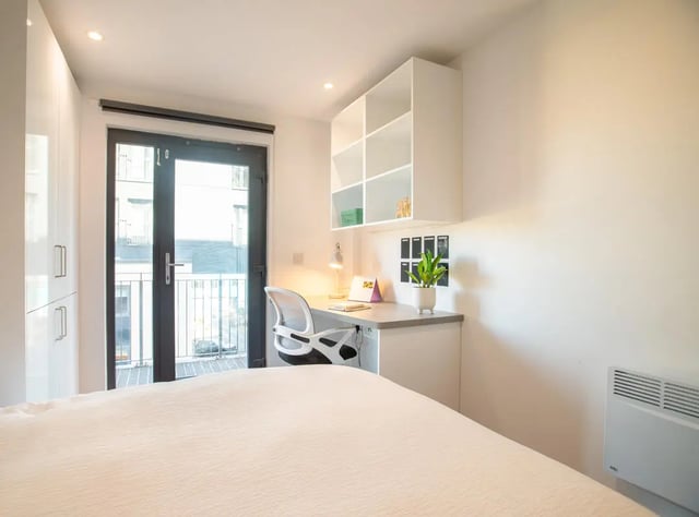 Desk chair shelves plant bedside bedroom at The Bridge Phase II in Newcastle Upon Tyne Student Accommodation