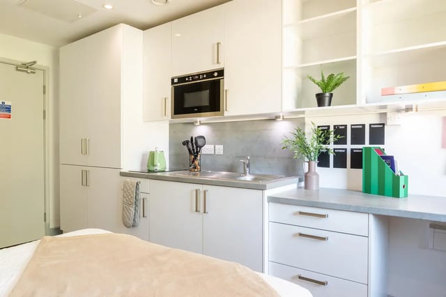 Modern white kitchen with microwave and kettle kitchen at The Bridge Phase II in Newcastle Upon Tyne Student Accommodation