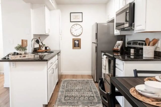 Stainless steel appliances white cabinets dark counters kitchen at Cedar Flats Student Housing in St. George Student Accommodation