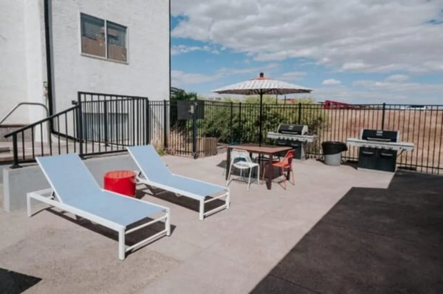 Sun loungers grills and table with chairs outdoor area at Cedar Flats Student Housing in St. George Student Accommodation