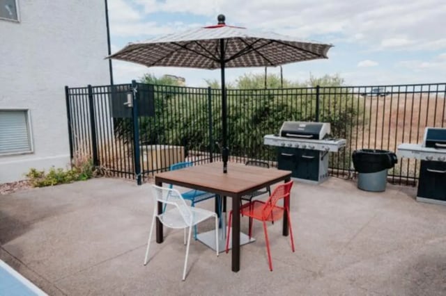 Table with chairs and grills exterior at Cedar Flats Student Housing in St. George Student Accommodation