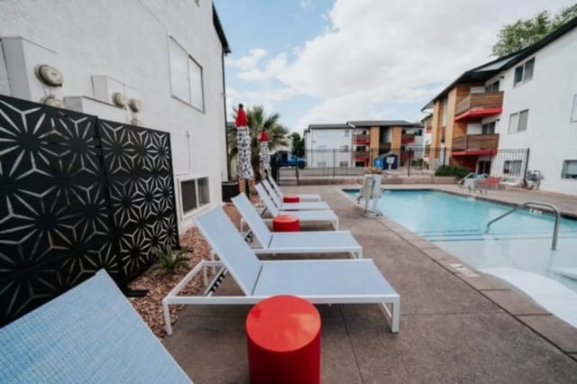 Deck chairs and pool with umbrellas playing area at Cedar Flats Student Housing in St. George Student Accommodation