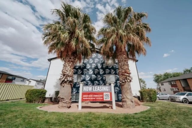 Now leasing sign palm trees exterior at Cedar Flats Student Housing in St. George Student Accommodation