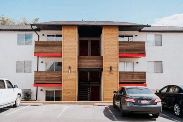 Apartment building with balconies and parked cars exterior at Cedar Flats Student Housing in St. George Student Accommodation