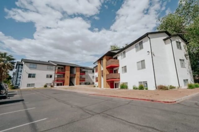 Apartments with balconies and parking lot exterior at Cedar Flats Student Housing in St. George Student Accommodation