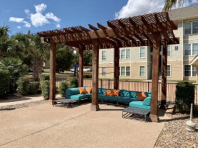 Pergola with teal couches and orange cushions outdoor lounge area at Angelo Place Apartments in San Angelo Student Accommodation