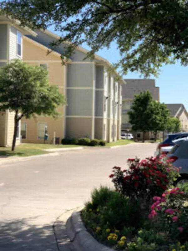 Apartment buildings with landscaping and cars Exterior at Angelo Place Apartments in San Angelo Student Accommodation