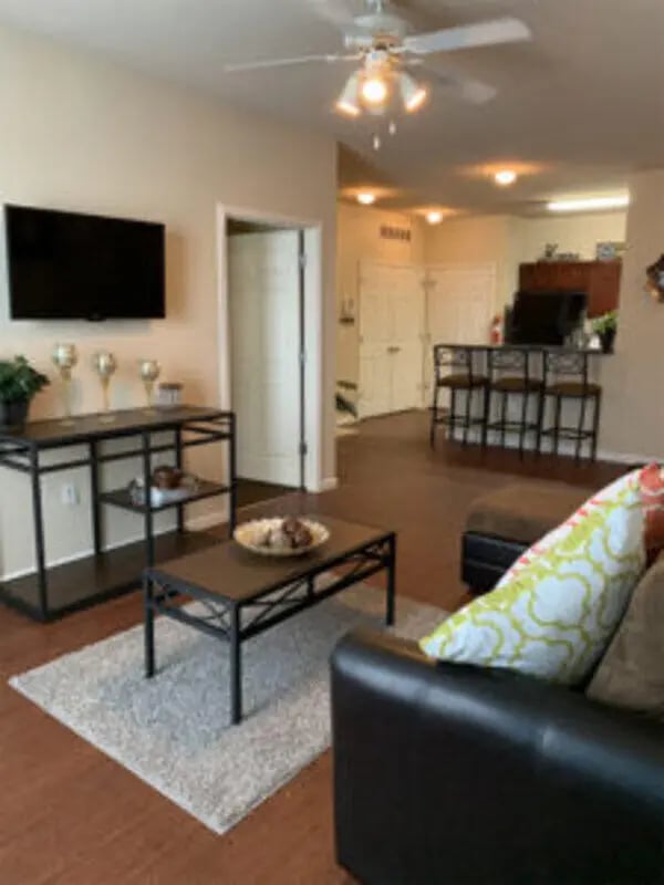 TV coffee table rug sofa living room at Angelo Place Apartments in San Angelo Student Accommodation