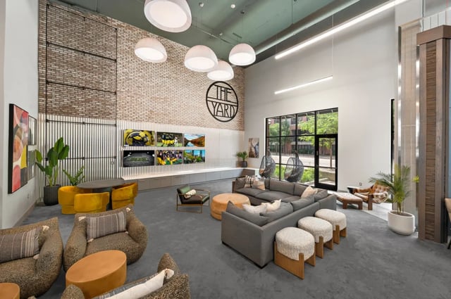 Sofas chairs screens and tables lounge area at The Yard in Ann Arbor Student Accommodation