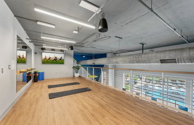 Yoga mats exercise equipment and televisions gym at The Yard in Ann Arbor Student Accommodation