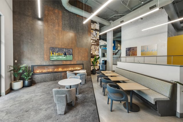 Fireplace television seating dining tables common area at The Yard in Ann Arbor Student Accommodation