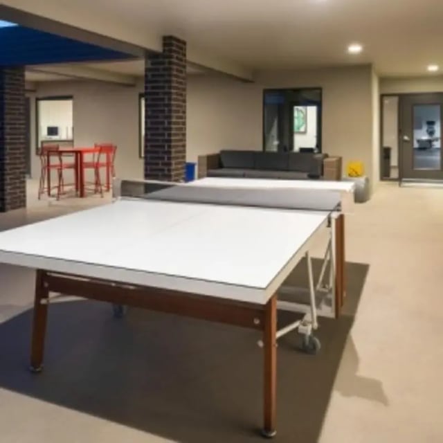 Ping pong table sofa and chairs common area at Eastgate Apartments in Waco Student Accommodation