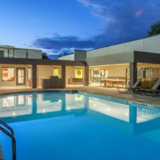 Pool lounge chairs grilling station and tables exterior at Eastgate Apartments in Waco Student Accommodation