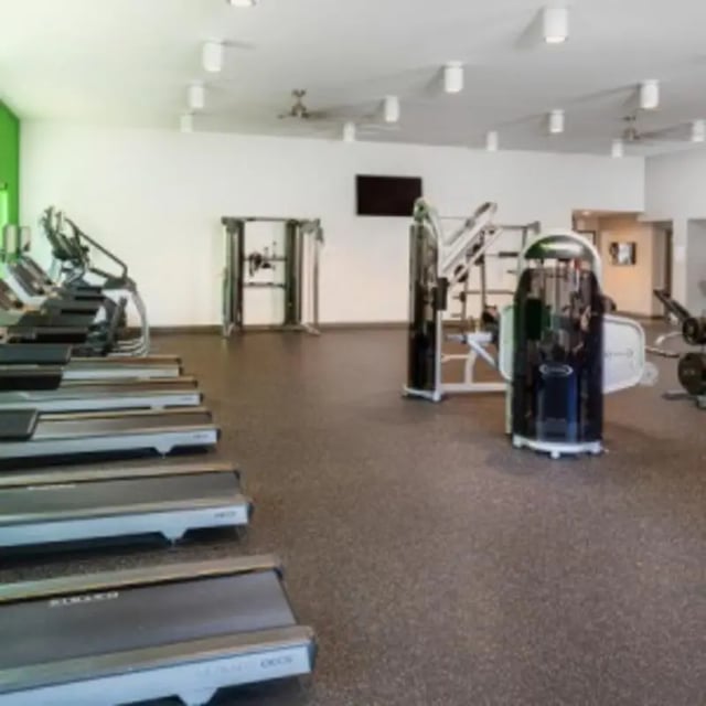Treadmills and weight machines in fitness center gym at Eastgate Apartments in Waco Student Accommodation