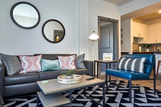 Sofa pillows mirrors coffee table modern living room at 848 Mitchell in Arlington Student Accommodation