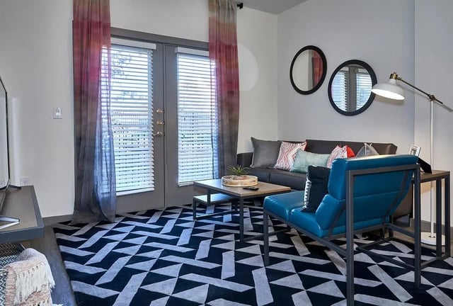 Sofa coffee table and blue chair living room at 848 Mitchell in Arlington Student Accommodation