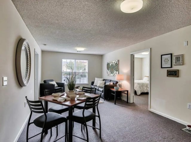Dining area with table chairs sofa and bedroom view Living area at Campus Pointe in Kent Student Accommodation