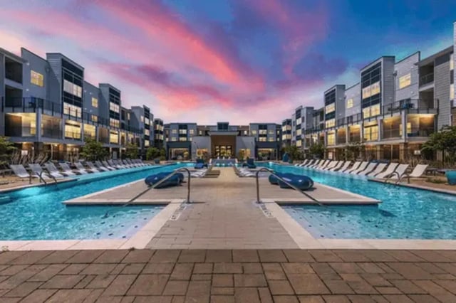 Modern apartments surrounding a long pool exterior at URSA in Waco Student Accommodation