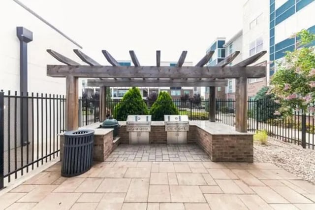 Outdoor grills under pergola with trash bin playing area at URSA in Waco Student Accommodation