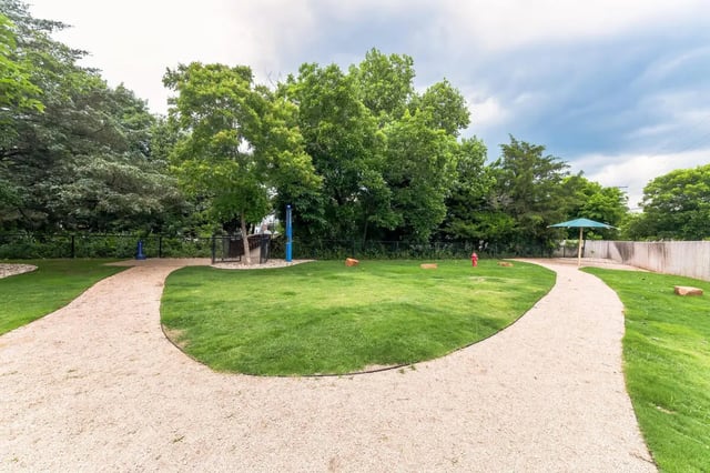 Grassy dog park with paths and trees dog park at URSA in Waco Student Accommodation