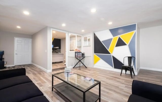 Sofa table chair geometric wall living room at USC Student Housing: Heritage 2353 in Los Angeles Student Accommodation
