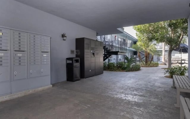 Mailboxes lockers trash can and courtyard exterior at USC Student Housing: Heritage 2353 in Los Angeles Student Accommodation