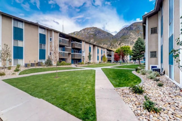 Apartment buildings with balconies and grass exterior at Centennial Apartments in Provo Student Accommodation