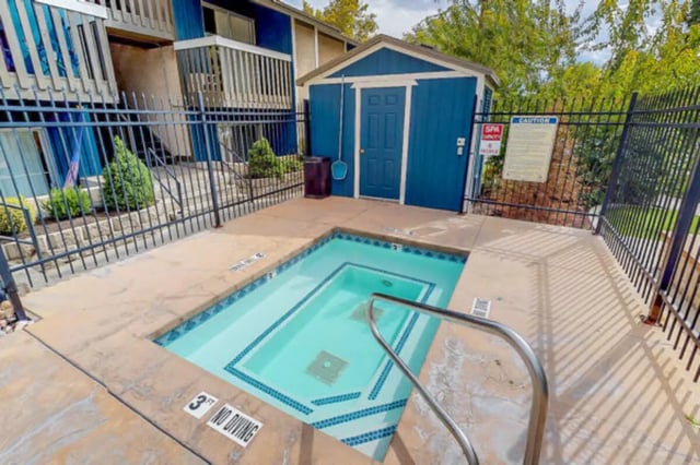 Small blue spa pool next to building exterior at Centennial Apartments in Provo Student Accommodation