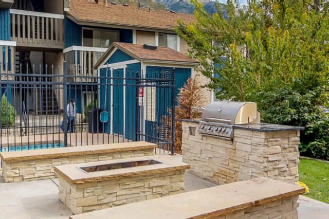 Grill fire pit pool and seating area exterior at Centennial Apartments in Provo Student Accommodation