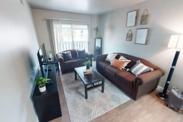 Two sofas coffee table television and rug living room at Centennial Apartments in Provo Student Accommodation