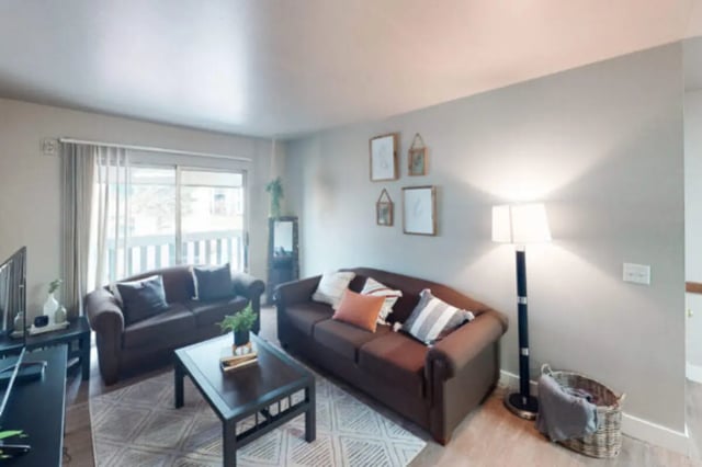 Two brown sofas coffee table floor lamp living room at Centennial Apartments in Provo Student Accommodation