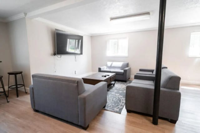 Gray sofas coffee table wall mounted TV living room at Centennial Apartments in Provo Student Accommodation