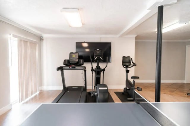 Gym equipment with ping pong table playing area at Centennial Apartments in Provo Student Accommodation