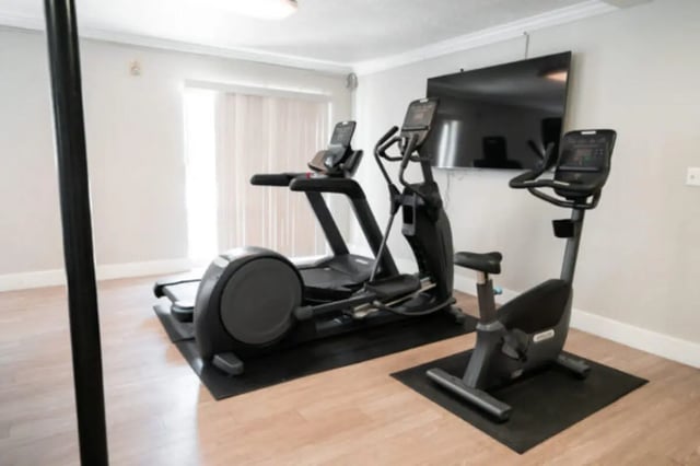 Treadmill elliptical bike wall mounted tv gym area at Centennial Apartments in Provo Student Accommodation