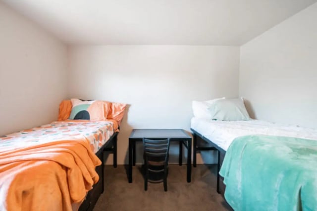 Two beds with desk and chair bedroom at Centennial Apartments in Provo Student Accommodation