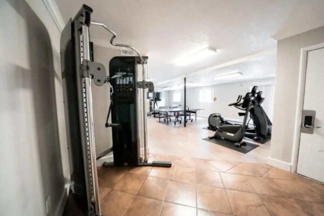 Gym equipment exercise bikes ping pong table recreation area at Centennial Apartments in Provo Student Accommodation