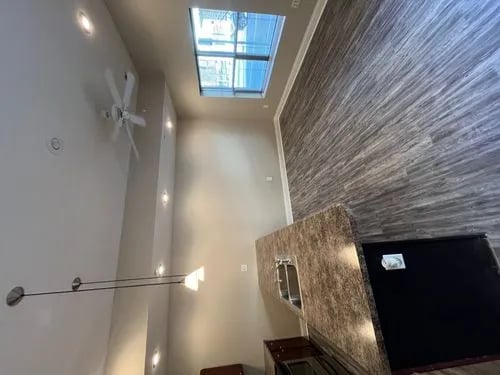 Ceiling fan pendant lights skylight textured wall kitchen at 9 North Apartments in Bloomington Student Accommodation