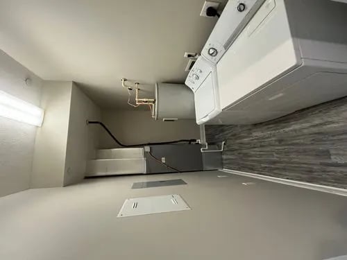 Washer dryer and water heater utility area at 9 North Apartments in Bloomington Student Accommodation