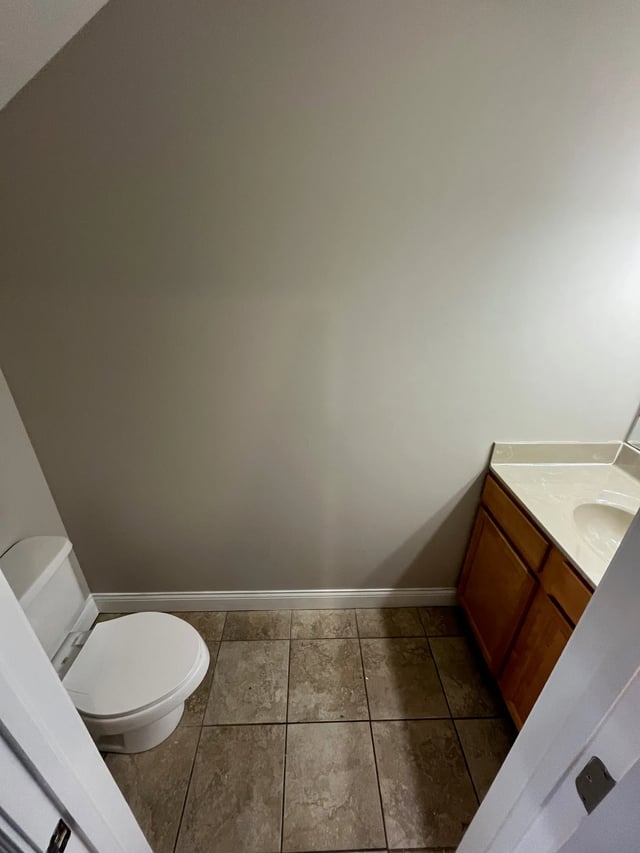 Toilet vanity and tiled floor bathroom at 9 North Apartments in Bloomington Student Accommodation